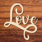 Wooden decorative sign with 'love' on a wooden background