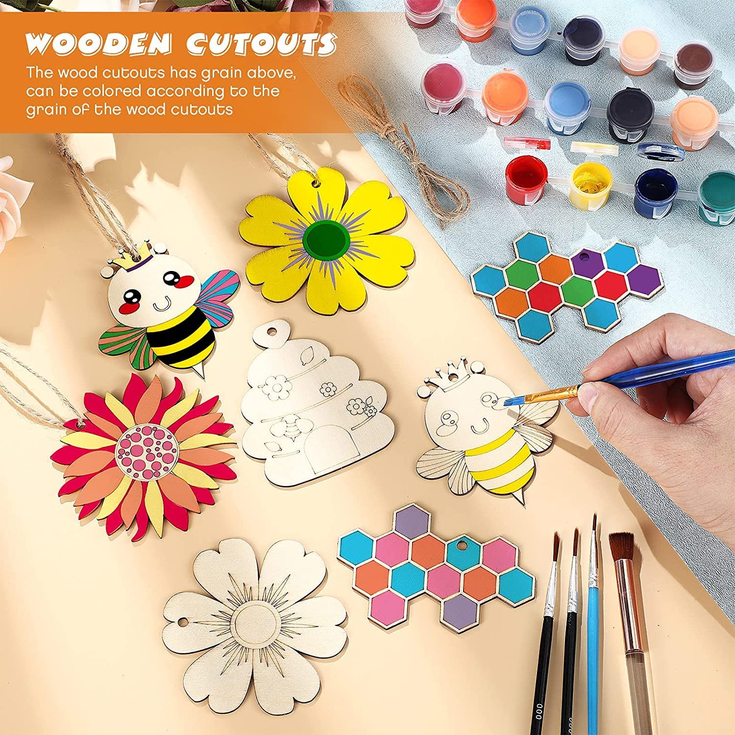 Wooden cutouts with paint and brushes on a wooden surface