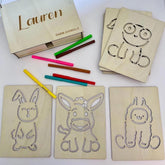 Wooden cards with farm animal outlines and colored pencils on a white background