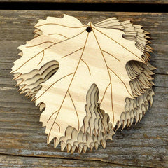 Wooden leaf-shaped cutout on a wooden surface