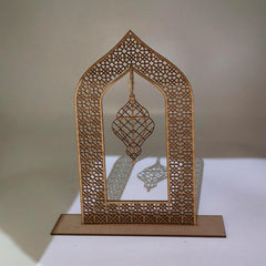 Decorative wooden arch with intricate cut-out patterns on a plain background