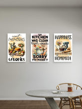 Three kitchen-themed wall posters on a wall above a dining table.