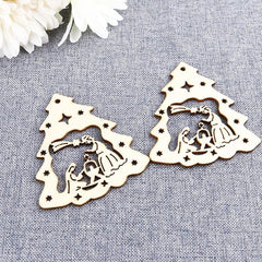 Two wooden nativity scene cutouts on a gray fabric background.