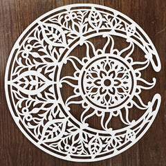 Decorative white cutout with intricate patterns on a wooden background
