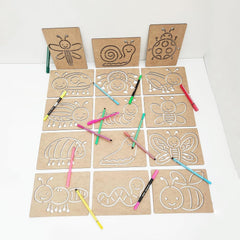 Set of cardboard templates with animal outlines and colored pencils on a white background