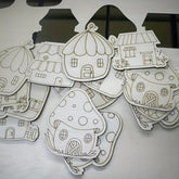 Collection of paper house cutouts on a white surface