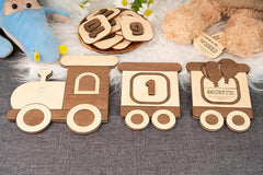 Wooden toys shaped like a train with numbers and letters on a textured surface.