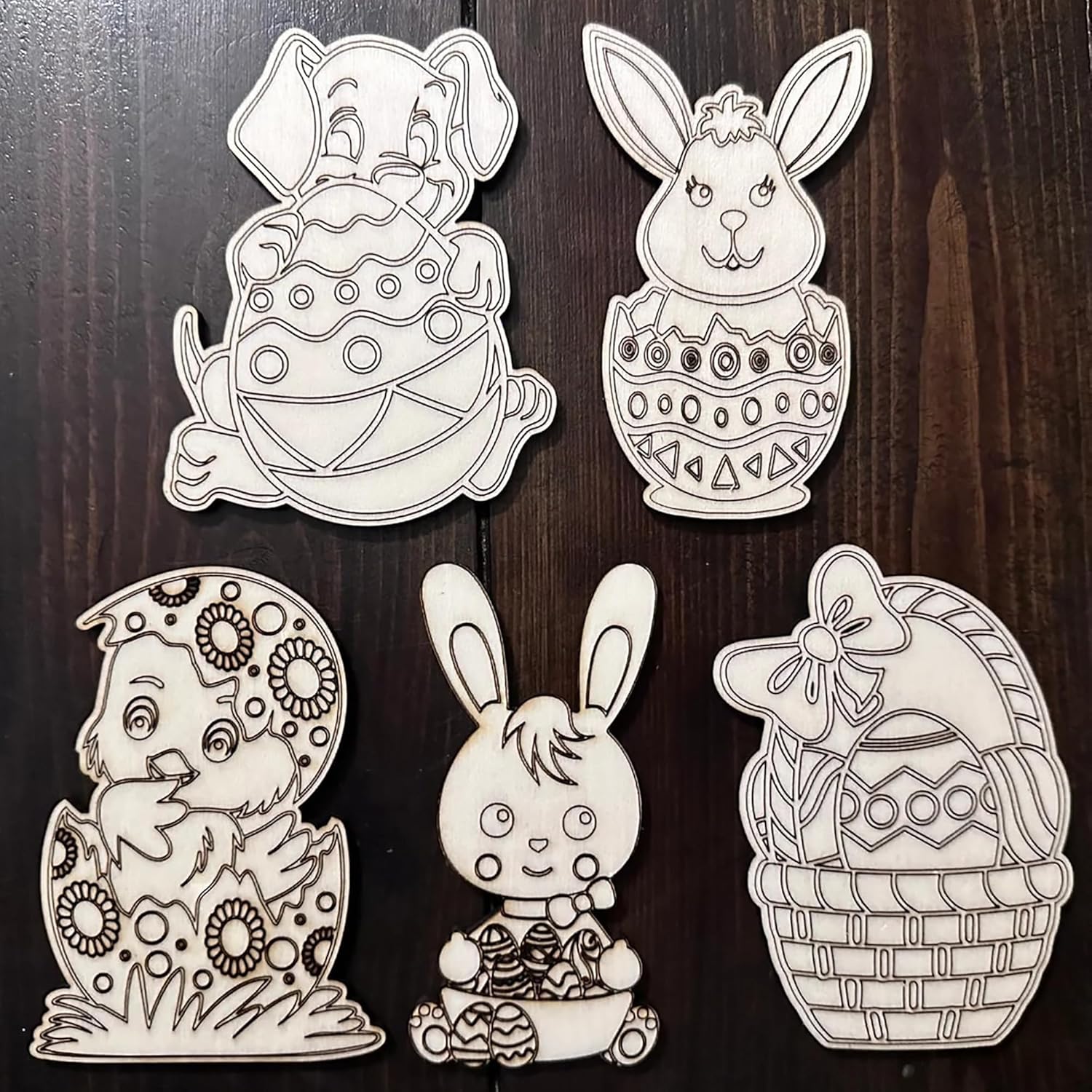 Set of five black and white Easter-themed cutouts on a wooden surface