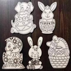 Set of five black and white Easter-themed cutouts on a wooden surface