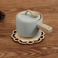 Ceramic pot with lid on a wooden surface