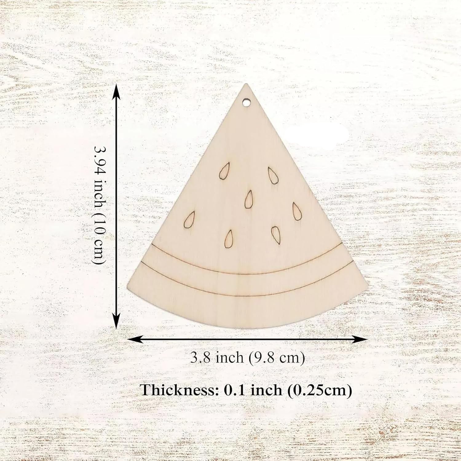 Wooden watermelon slice ornament with measurements on a textured beige background