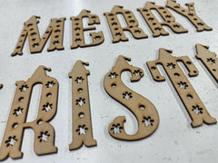 Wooden Christmas decorations with 'Merry Christmas' text on a white background