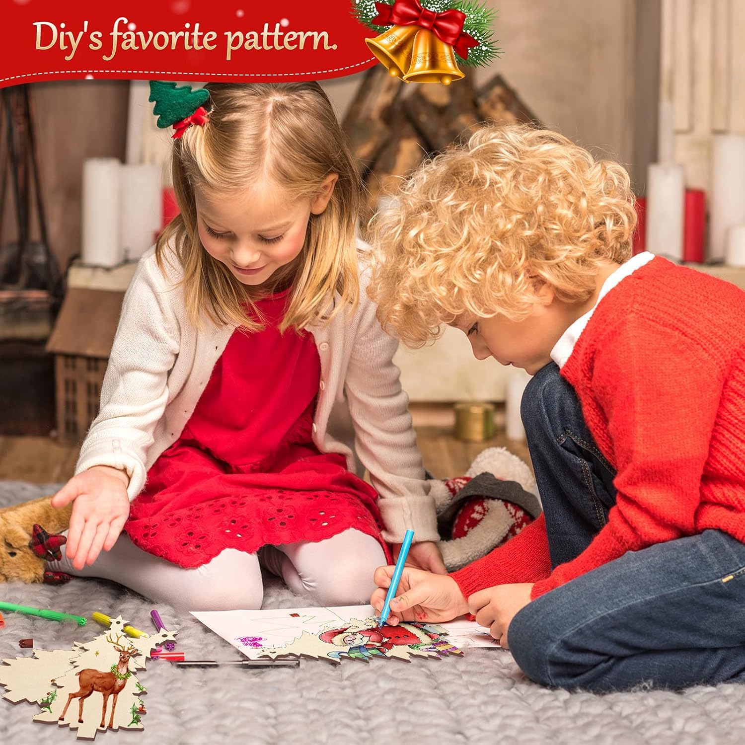 Two children sitting on a carpet, engaged in a craft activity with Christmas decorations.