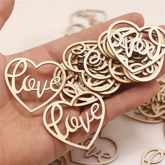 Hand holding wooden heart-shaped 'love' ornaments on a light background