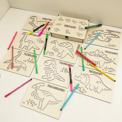Coloring book with dinosaur illustrations and colored pencils on a white surface