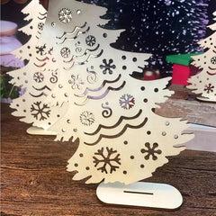 Decorative Christmas tree made of paper with cut-out snowflakes on a wooden surface.