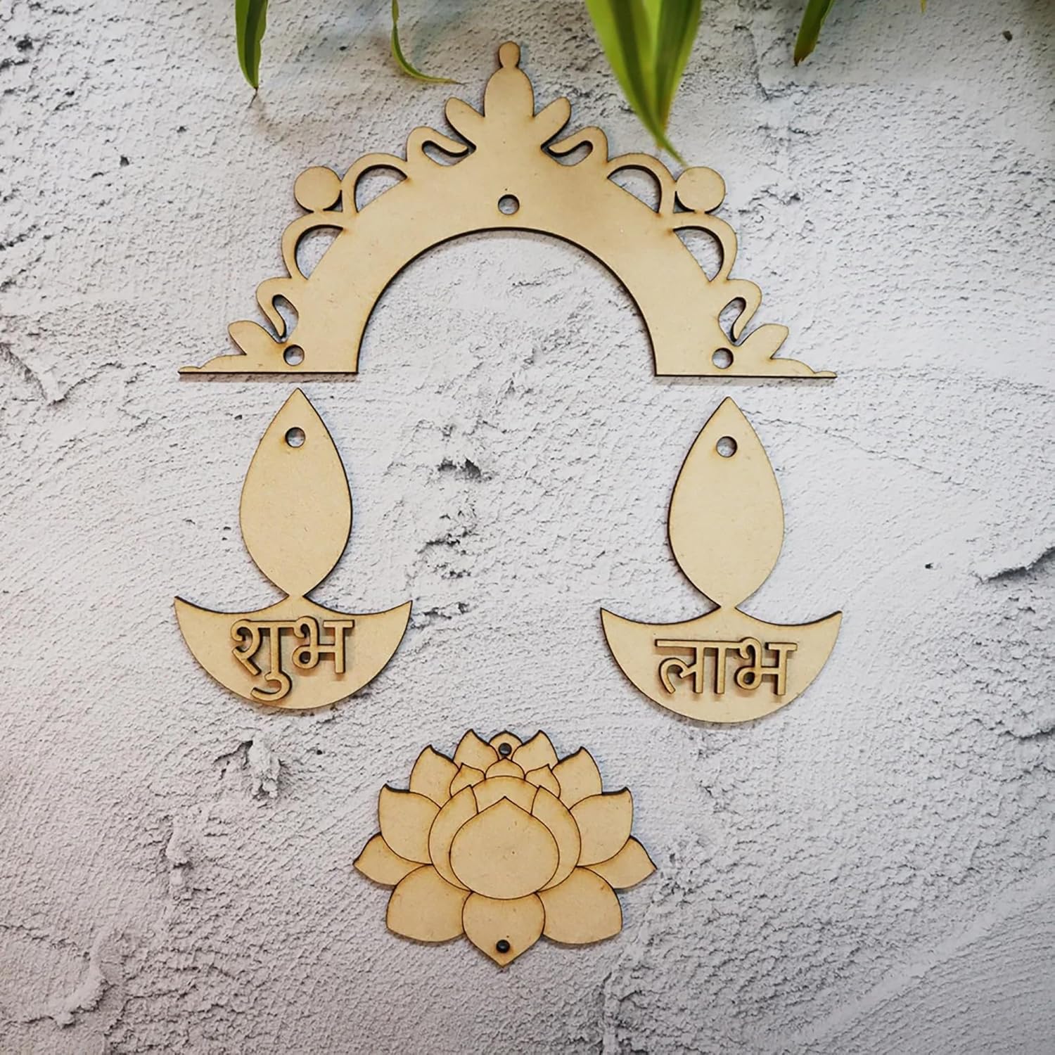 Decorative wooden items including an arch, leaf-shaped pieces with text, and a lotus flower on a textured white surface.