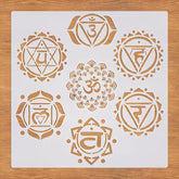 Set of gold chakra symbols on a white card with a wooden surface background