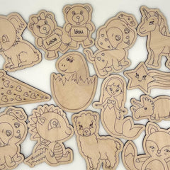 Collection of wooden cutouts with various animal and abstract designs on a white background