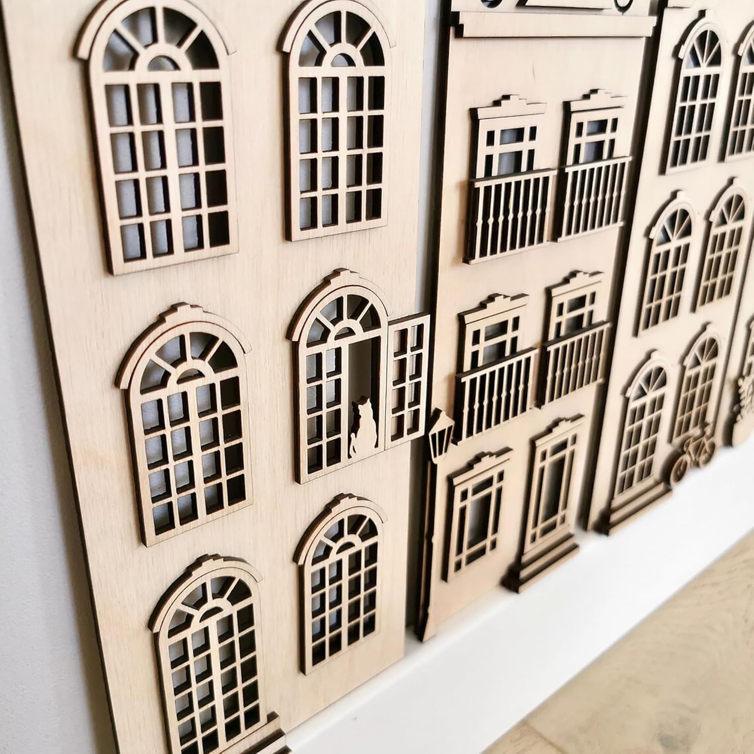 Wooden architectural model with detailed windows on a white background