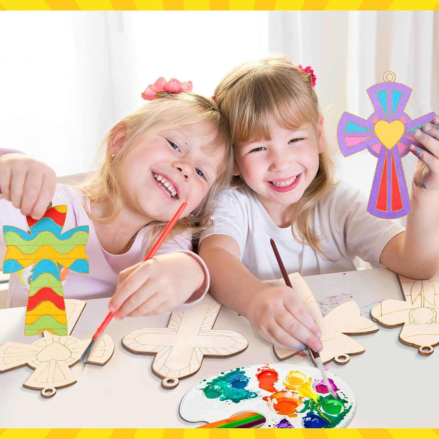 Two children painting wooden crafts with colorful paints on a table.