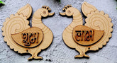 Two wooden peacock carvings with engraved text on a gray background