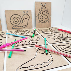 Cardboard templates with animal shapes and markers on a white background