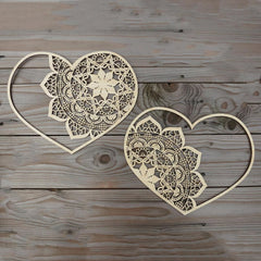 Two heart-shaped lace patterns on a wooden surface