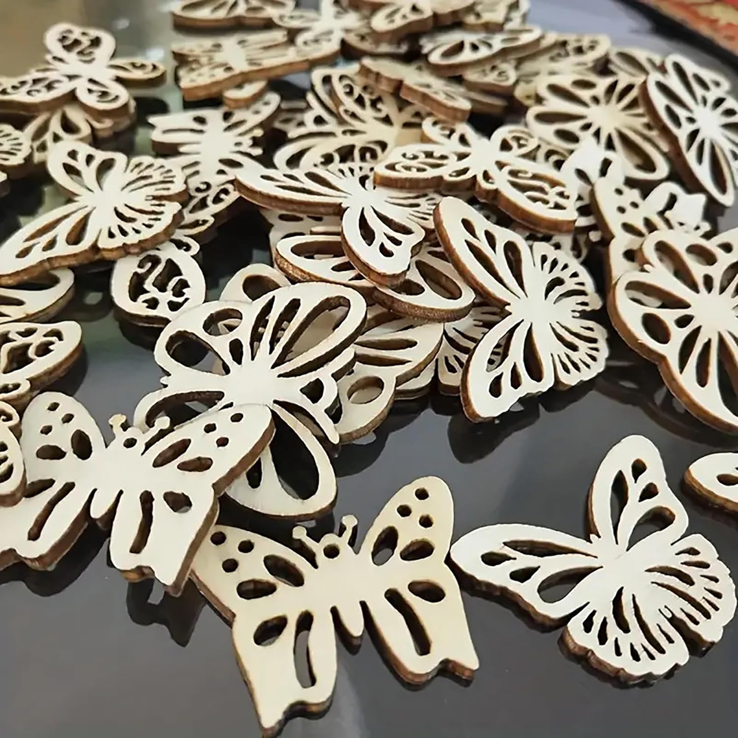 Wooden butterfly decorations on a reflective surface