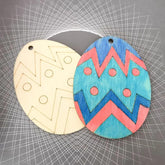 Two wooden cutouts with geometric patterns on a gray grid background