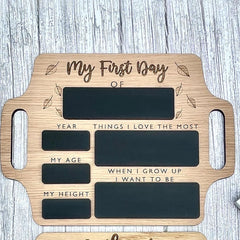 Wooden plaque with engraved text for 'My First Day' on a wooden surface