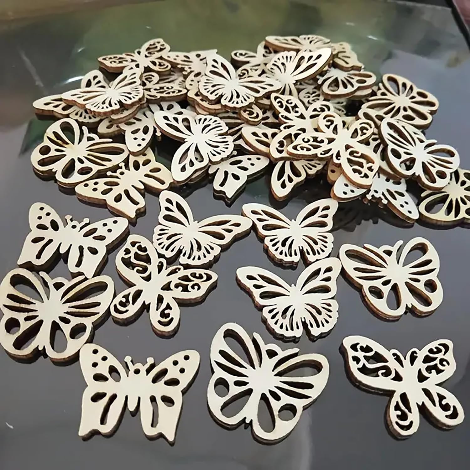 Wooden butterfly decorations on a reflective surface