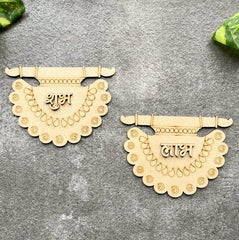 Two decorative wooden pendants with intricate designs on a gray surface.