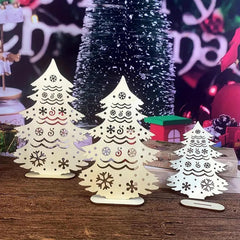 Decorative Christmas trees with snowflake patterns on a wooden surface.