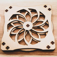 Wooden cooling pad with geometric design on a wooden surface