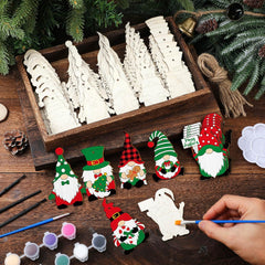 Wooden Christmas tree ornaments in a box with hand-painted gnomes on a wooden surface.