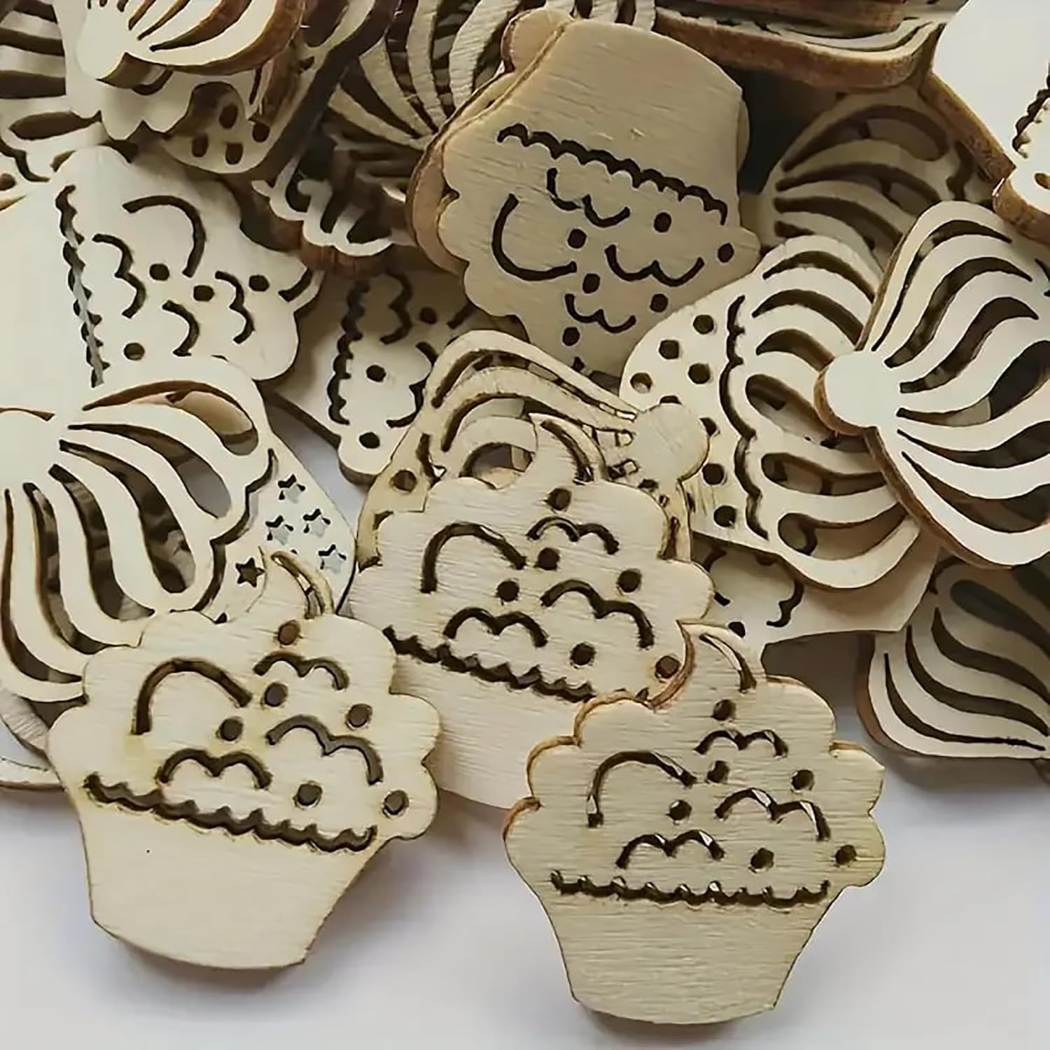 Wooden cutouts with laser-engraved designs on a white background