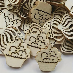 Wooden cutouts with laser-engraved designs on a white background
