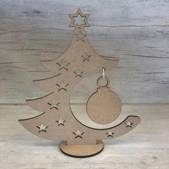 Wooden Christmas tree decoration with stars and a ball on a wooden background