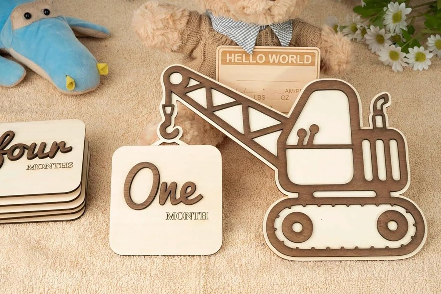 Wooden milestone cards with construction vehicle design and 'Hello World' card on a textured surface.