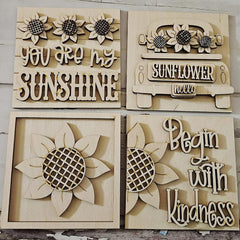 Four wooden wall art pieces with sunflower designs and text.