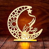 Decorative moon and star design with Arabic calligraphy on a wooden background