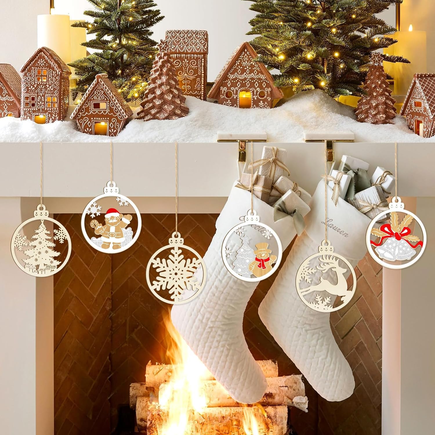 Christmas stockings hanging by a fireplace with decorated trees and gingerbread houses.