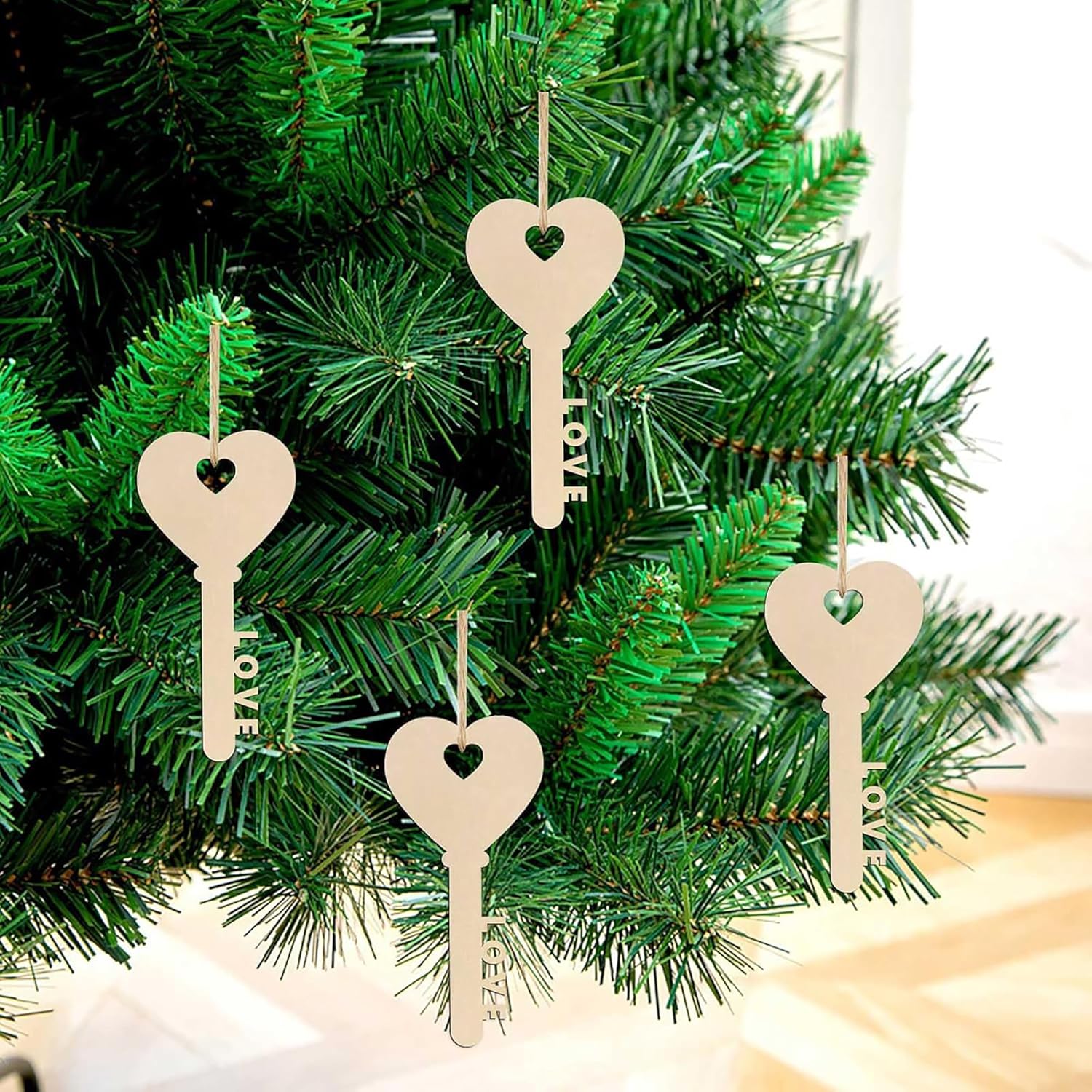 Wooden key-shaped ornaments with 'LOVE' on a Christmas tree.