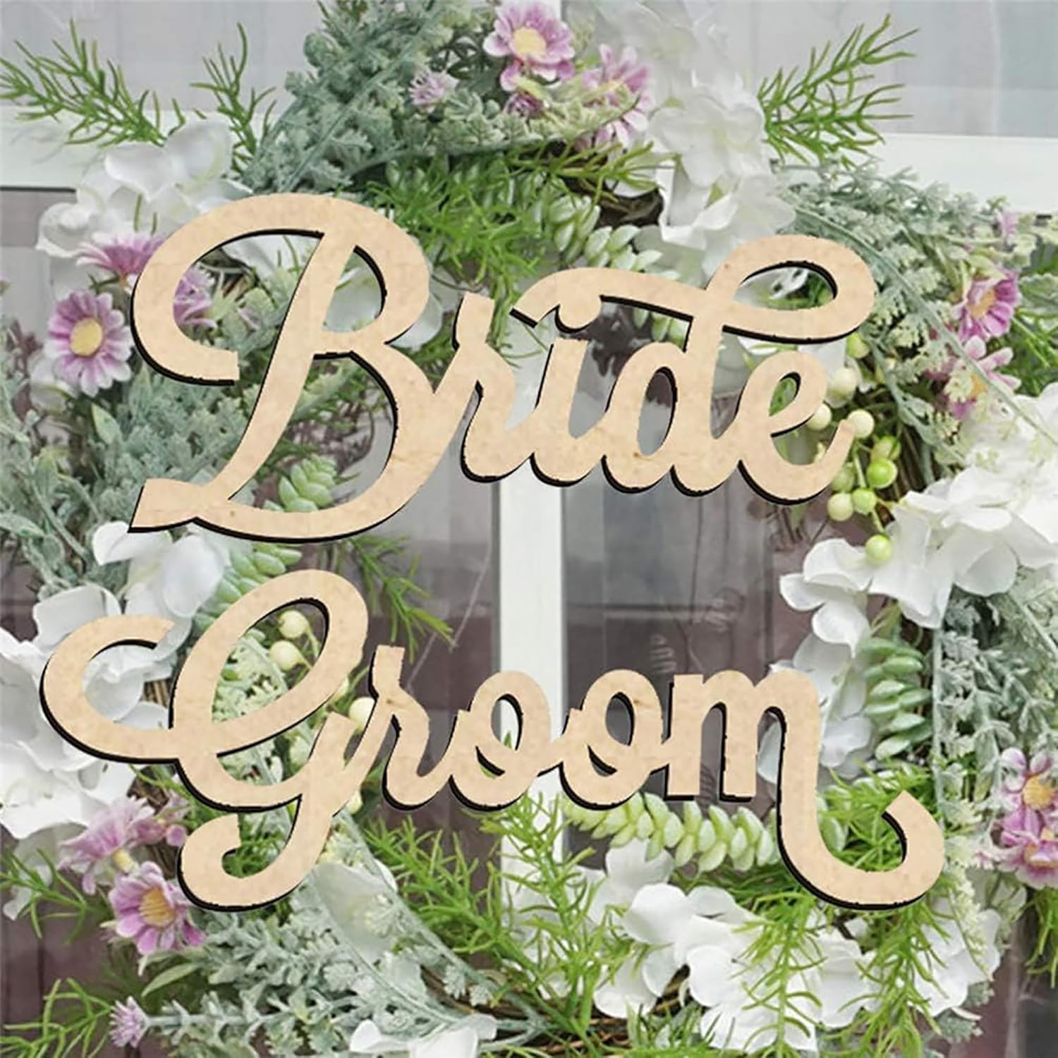 Wooden 'Bride' and 'Groom' signs on a floral wreath