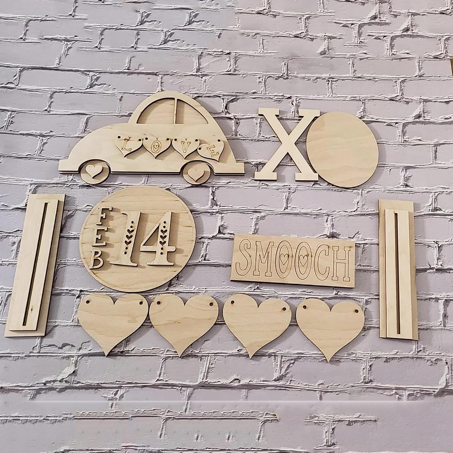 Wooden decorative items including a car, hearts, and 'Smooch' on a brick wall background