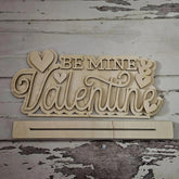 Wooden decorative sign with 'Be Mine Valentine' text on a rustic wooden background