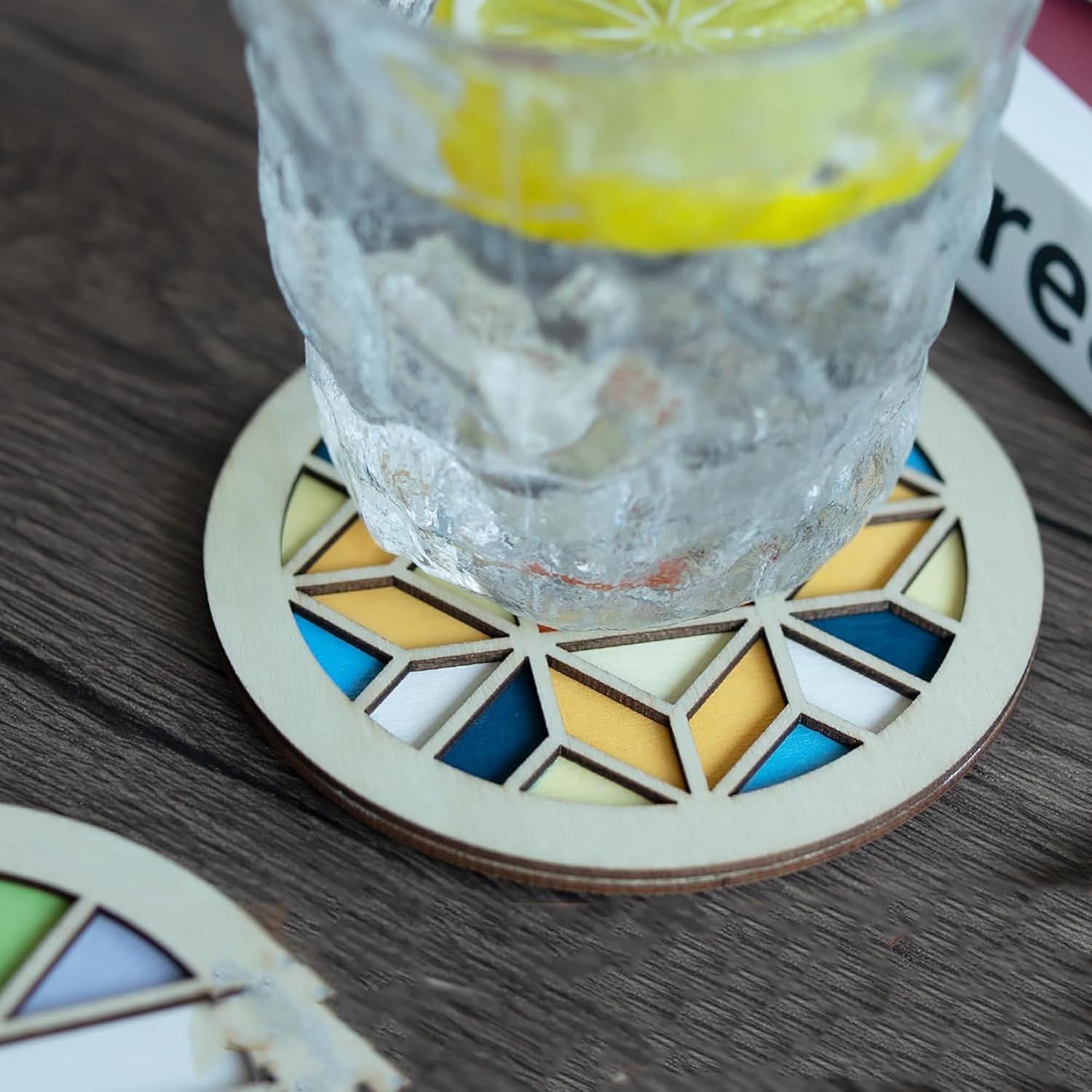 Glass of water with lemon on a geometric coasters