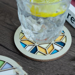 Glass of water with lemon on a geometric coasters