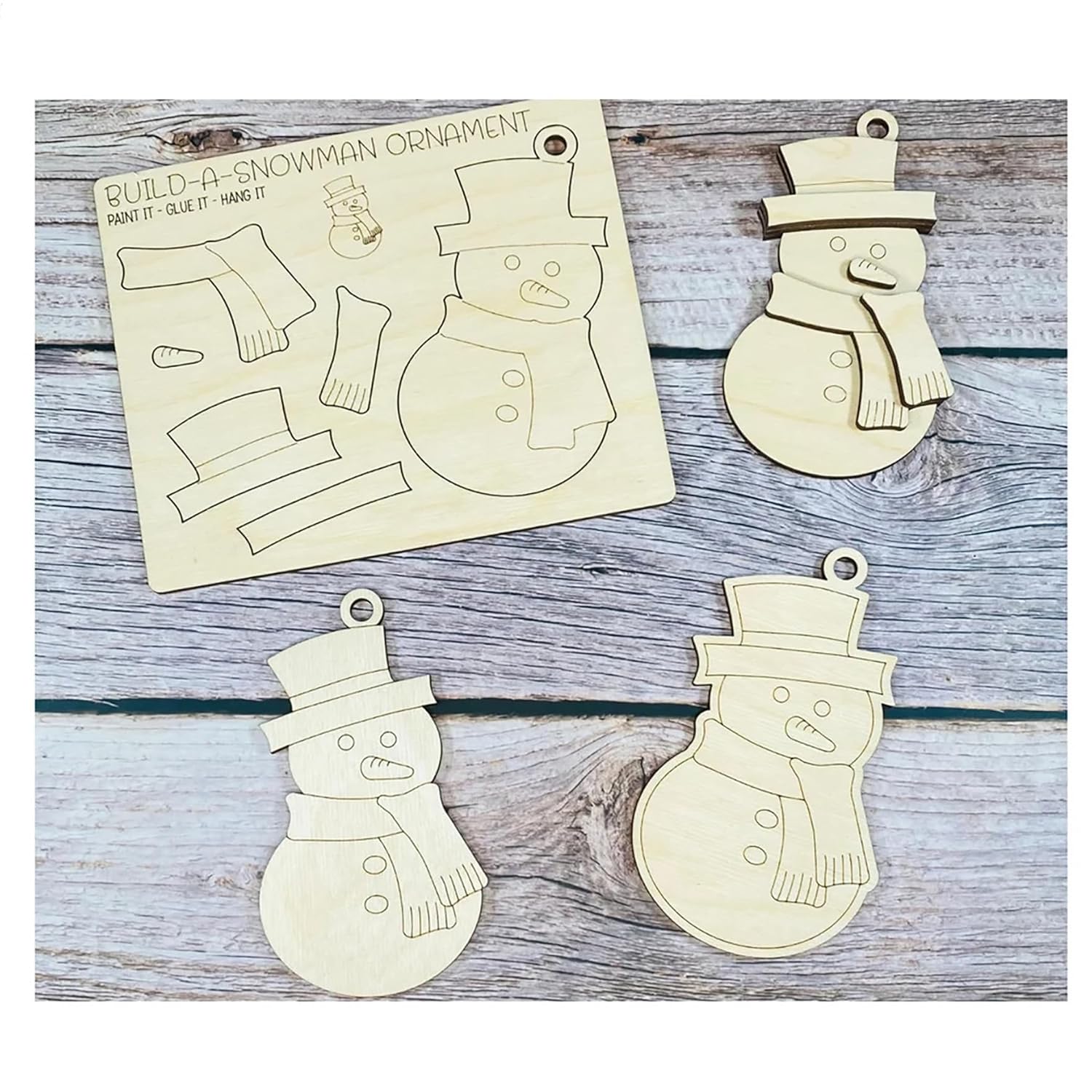 Wooden snowman ornaments and a template on a wooden surface
